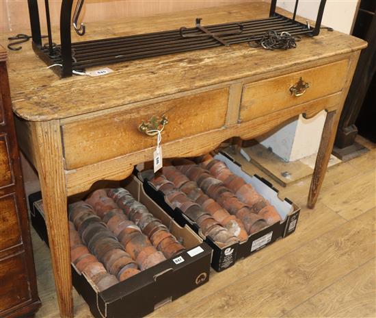 An early 19th century pine two drawer side table W.120cm